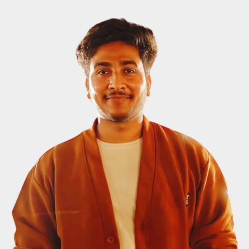 Yash Khunteta - JK Business School Gurugram | Top PGDM College in Delhi NCR - JK Business School Gurugram | Top PGDM College in Delhi NCR Young man with short dark hair, wearing an orange-brown jacket over a white shirt, smiling against a light background.